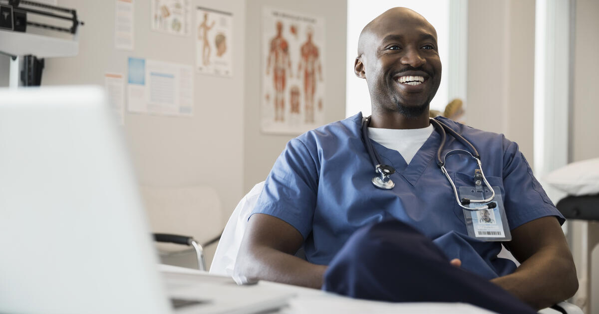 Smiling doctor in scrubs in clinic office